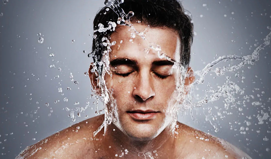 man applying moisturizer on face as part of simple 3 step skincare routine for men
