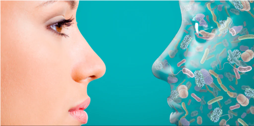 Close up of glowing healthy skin with colorful circles representing good bacteria balance on the surface