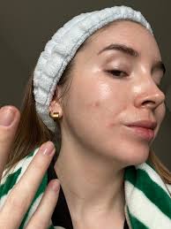 Skincare addiction signs with overwhelmed woman surrounded by excessive skincare products